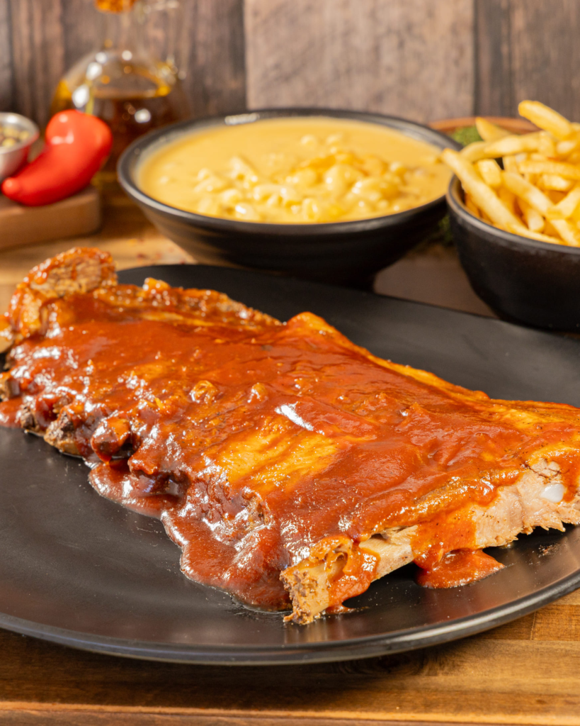 Family-style BBQ pork ribs with Brazilian sides