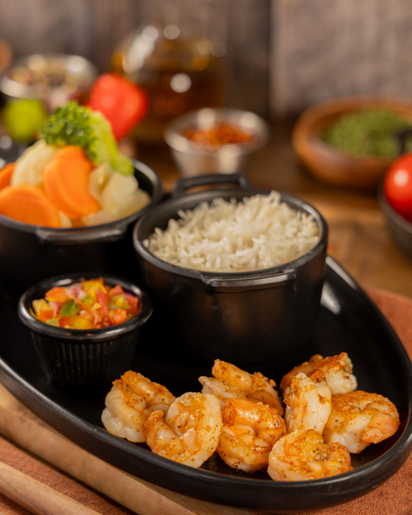 Grilled shrimp with garlic and herbs served with Brazilian sides