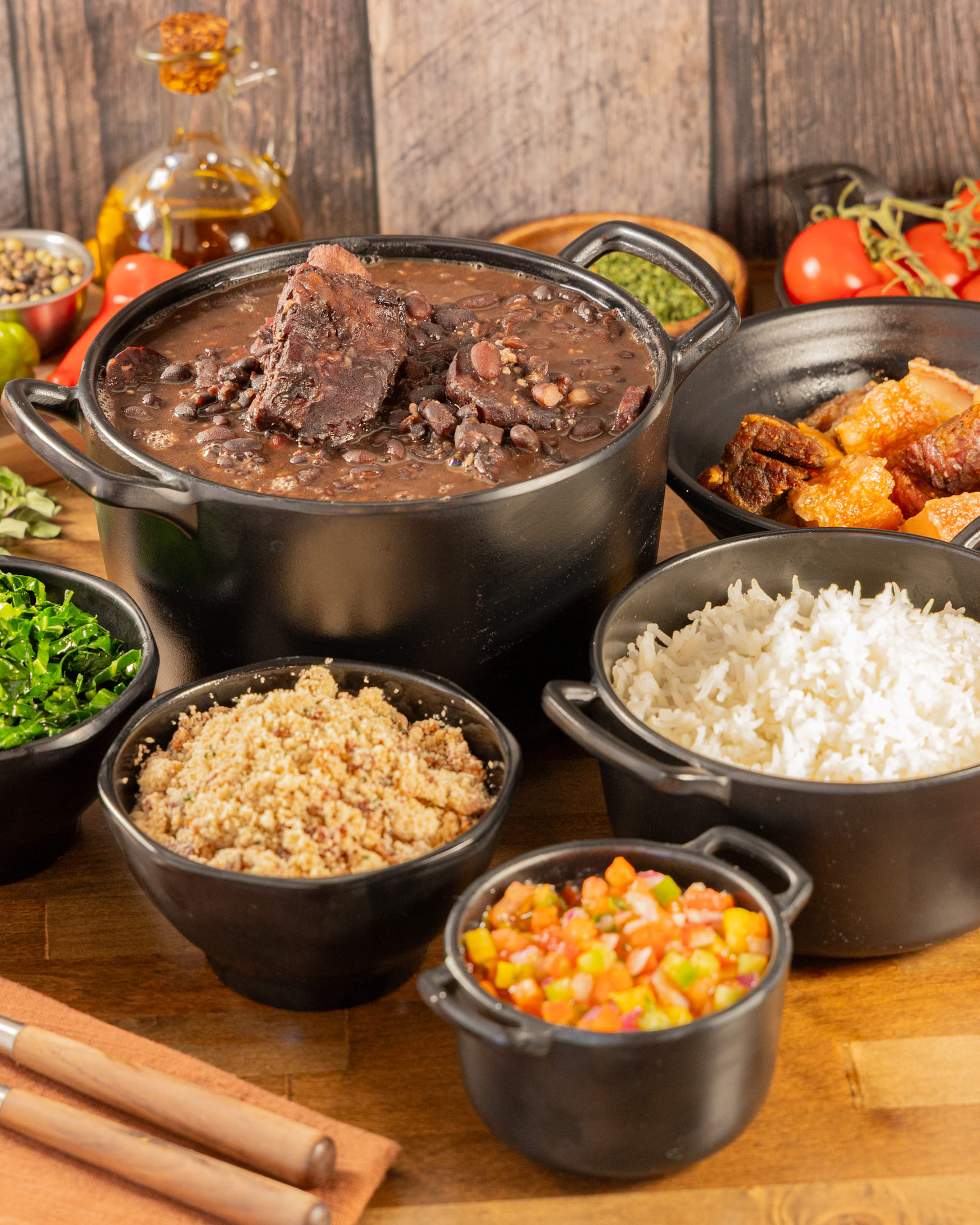 Brazilian feijoada with rice, collard greens, and farofa