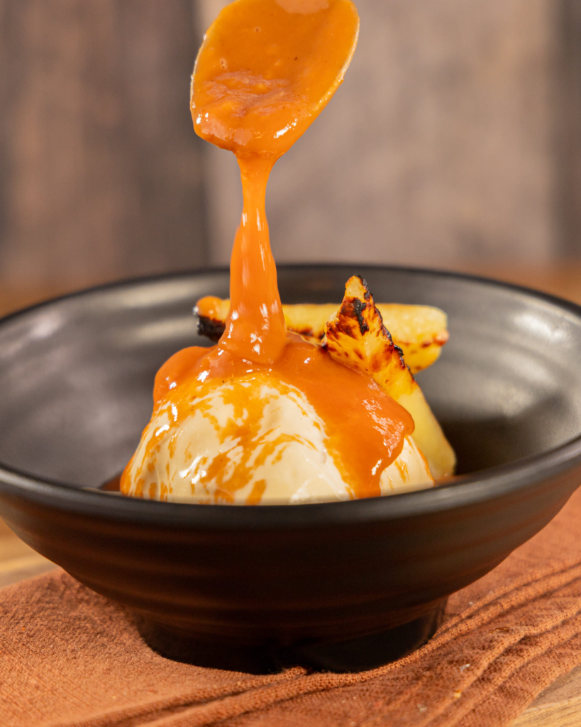 Cheese ice cream topped with warm guava sauce