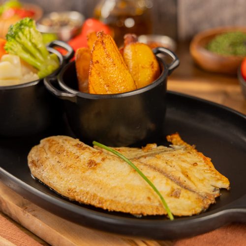 Tilapia with quinoa and roasted vegetables served at Kingdom BBQ & Grill in Orlando
